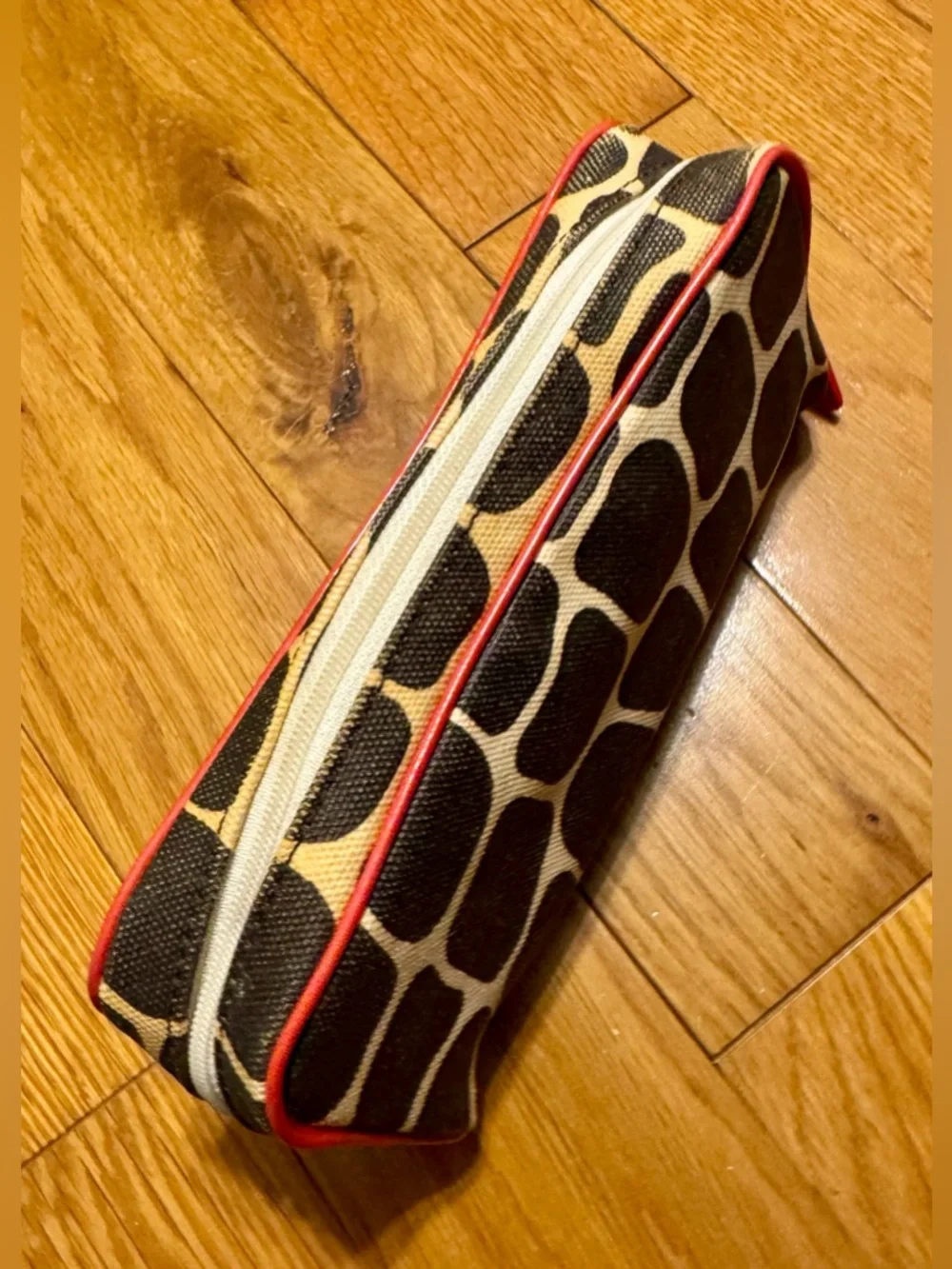 Kate Spade New York cosmetic bag or pencil case featuring a signature giraffe-